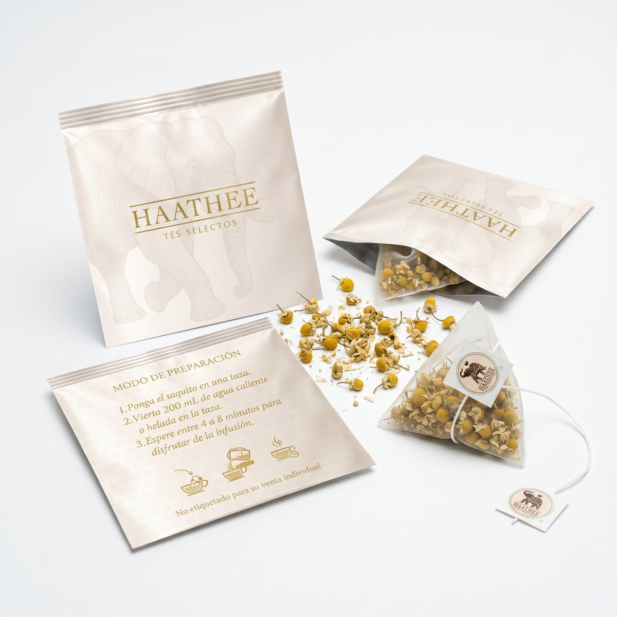 Manzanilla Deluxe Haathee: sachet piramidal, sobre abierto y flores de manzanilla.